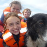 Smiling sailors and dog